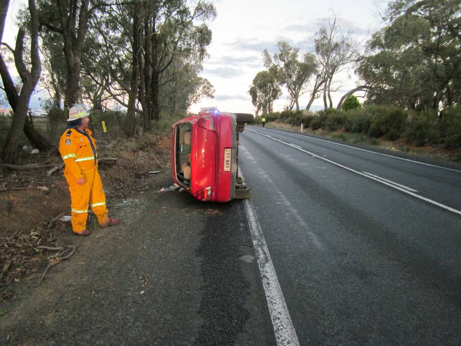 CRASH ZONE: Emergency services attend an accident on the Mitchell Highway on Monday night.