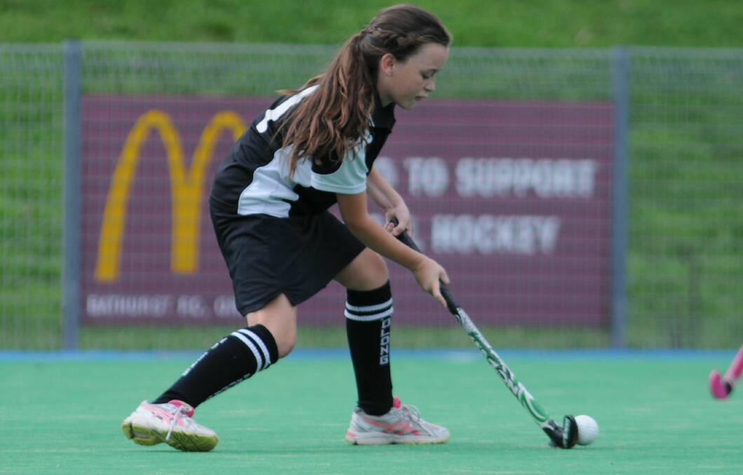 HOCKEY: Molong's Mardie Campbell prepares to pass in her side's under 12s game against CYMS on Saturday. Photo: STEVE GOSCH