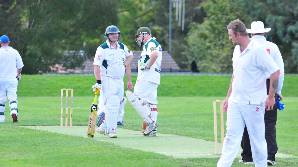 SECOND GRADE: Orange City's Dave Boundy and Andrew McIntyre have a mid-wicket conference at Max Stewart. Photo: JUDE KEOGH