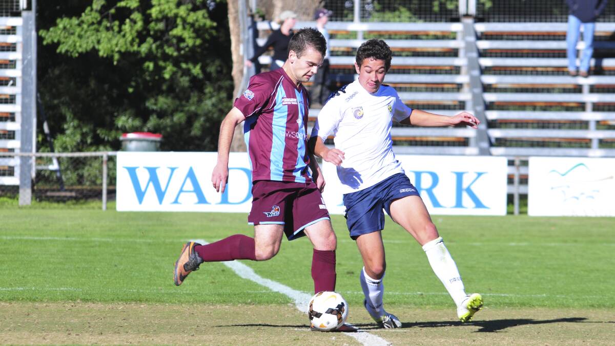 UNDER 18S: Hawkesbury FC' Luke Hall and Western Mariners' Preston Parker in the thick of the contest on Saturday. Photo: JUDE KEOGH