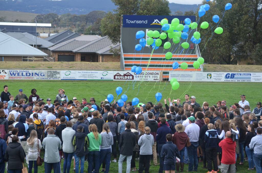 FLY HIGH: A minute's silence is held for Lochie Connaughton before balloons were released in his honour at Pride Park on Saturday. Photo: BRYSON FERREIRA. 0430tribute2