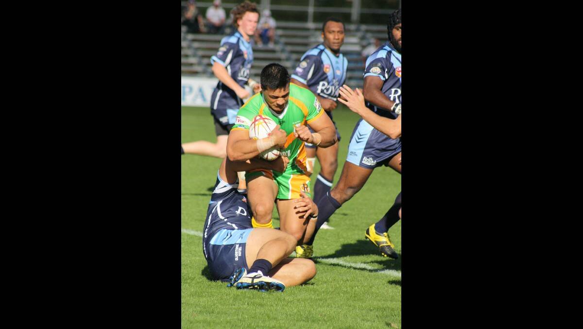 ORANGE CYMS: Winger Semisi Katoa busts through the Hawks defence. Photo: MICHELLE COOK