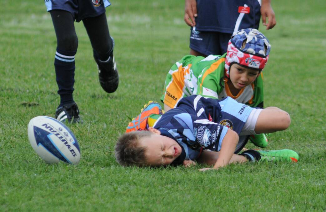 RUGBY LEAGUE: Riley Dane is brought down by the CYMS under 7s defence on Saturday. Photo: STEVE GOSCH
