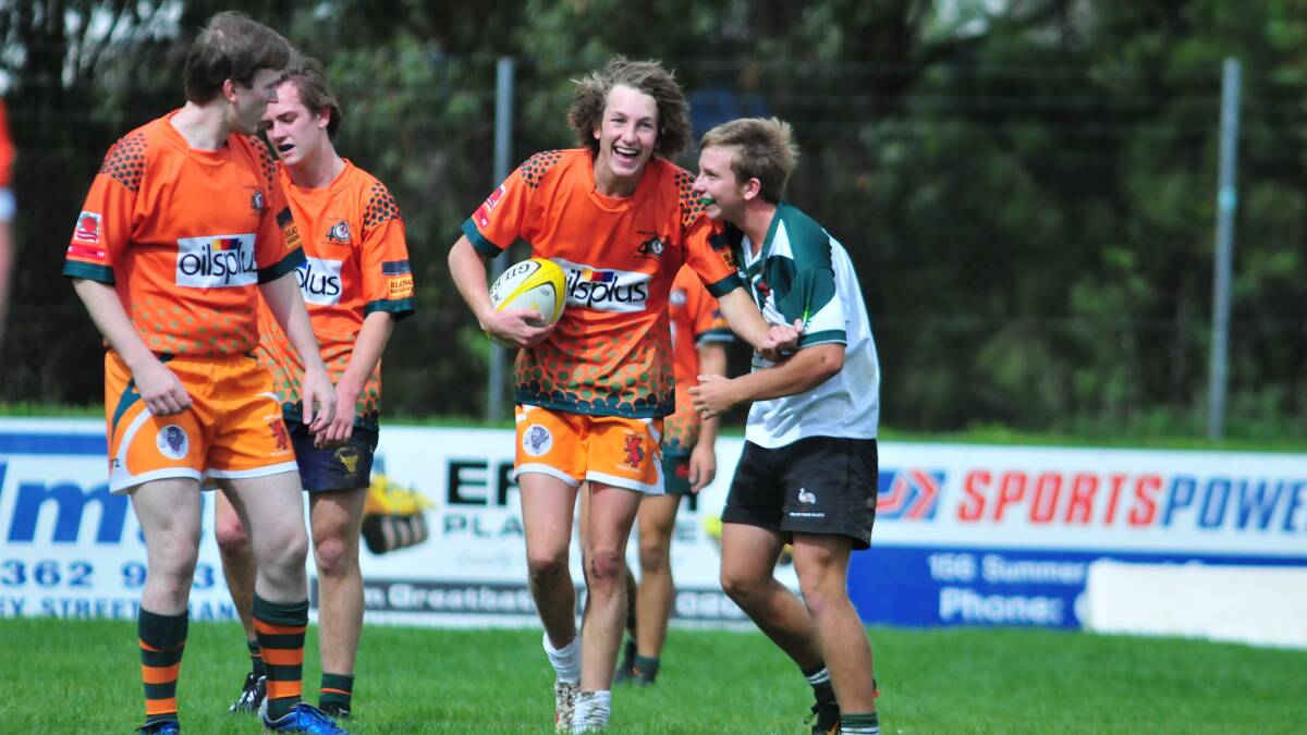 RUGBY UNION: Jimmy Ostini and Todd Farrell enjoy a joke as the half-time wistle blows in Saturday's trial between Orange City Lions and Orange Emus. Photo: JUDE KEOGH