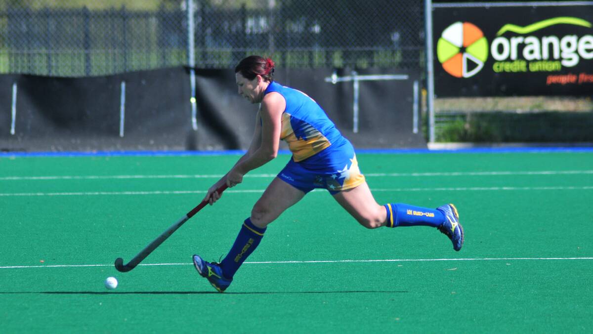 IN THE CLEARL Orange Ex-Services' Alison Baker makes a break for it against Orange Confederates on Saturday. Photo: JUDE KEOGH