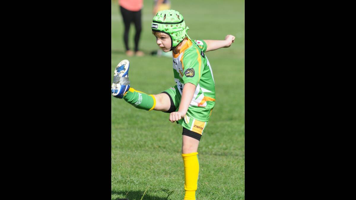 RUGBY LEAGUE: CYMS' under 7s' Hunter Mooney kicks long and straight against the Bloomfield Tigers. Photo: STEVE GOSCH