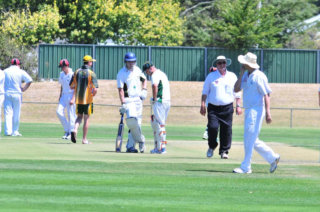 CRICKET: Orange CYMS batsmen Hugh Le Lievre and Nick Garton discuss their plans for the Centrals attack in the ODCA first grade game at Wade Park on Saturday. Photo: JUDE KEOGH