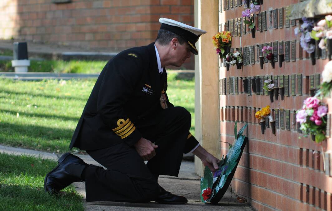 LEST WE FORGET: Captain Greg Laxton lays a wreath. Photo: STEVE GOSCH
