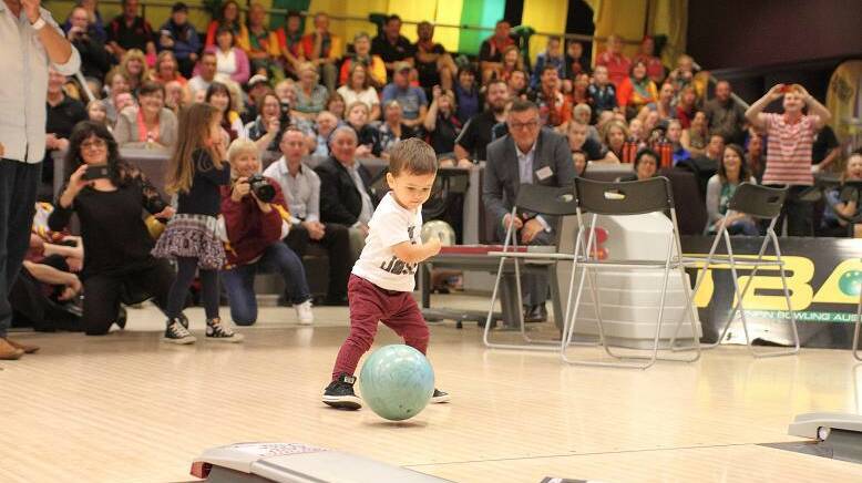 IT'S ON ITS WAY: Hugo Belmonte shows his dad Jason how it's done at Sydney's Tenpin City this week.