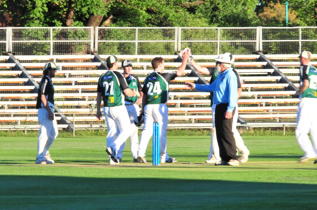 CRICKET: Orange City celebrate a wicket in Friday night's Royal Hotel Cup final against Cavaliers at Wade Park. Photo: JUDE KEOGH