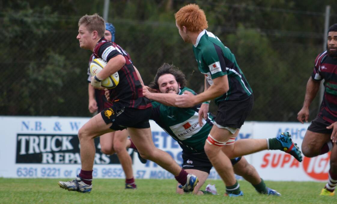 JUST GOT HIM: Parkes Boars' James Dean almost gets away from the desperate Orange Emus defence.