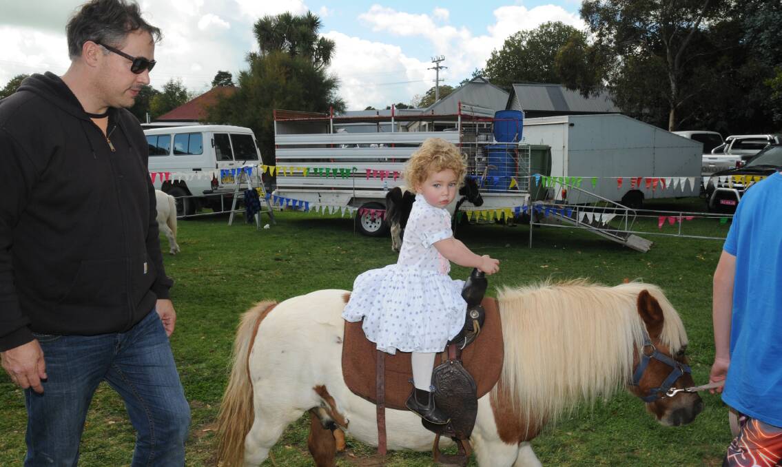 GOOD CLEAN FUN: Damien West watches on as Ingrid enjoys a pony ride. Photo: STEVE GOSCH