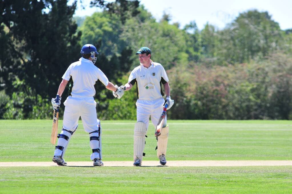 CRICKET: CYMS' skipper Hugh Le Lievre congratulates Dave Neil on his half century during Saturday's ODCA first grade game against Kinross Wolaroi. Photo: JUDE KEOGH
