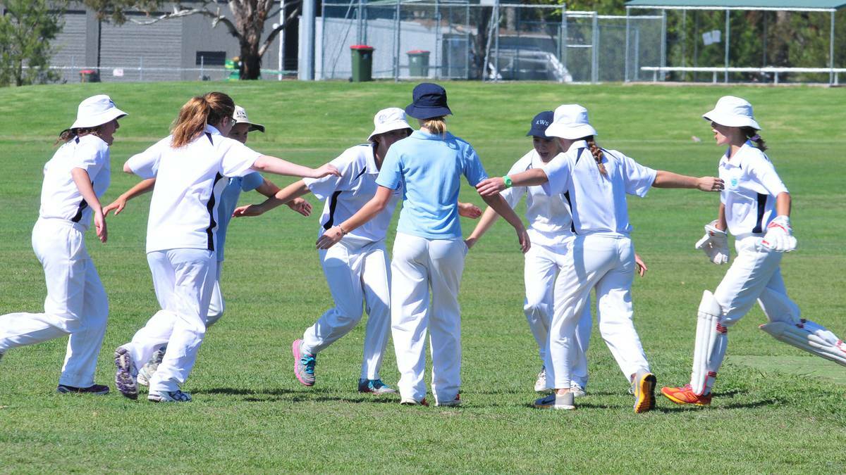 ORANGE: Kinross WOlaroi School's girls side celebrate a wicket in junior cricket on Saturday morning. Photo: JUDE KEOGH