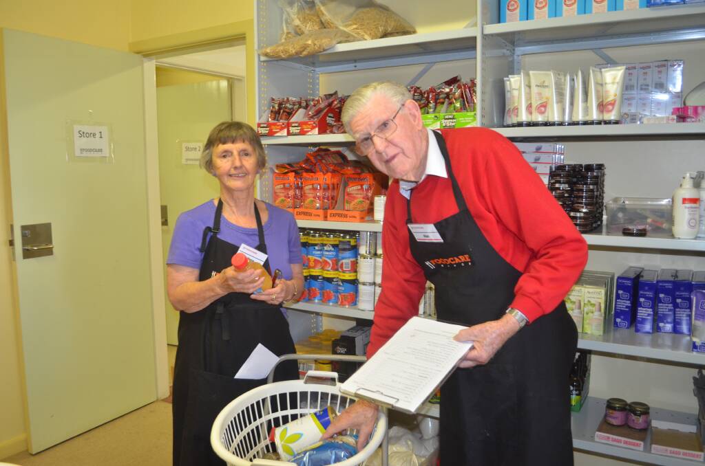 FoodCare committee member Anne Hopwood and volunteer Alan McAnulty. Photo: TRACEY PRISK