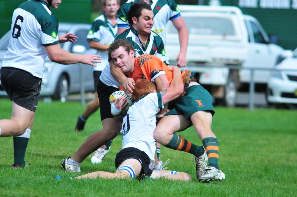 RUGBY UNION: Orange City Lions' Jake Davis crashes into the Orange Emus' defence at Endeavour Oval on Saturday. Photo: JUDE KEOGH