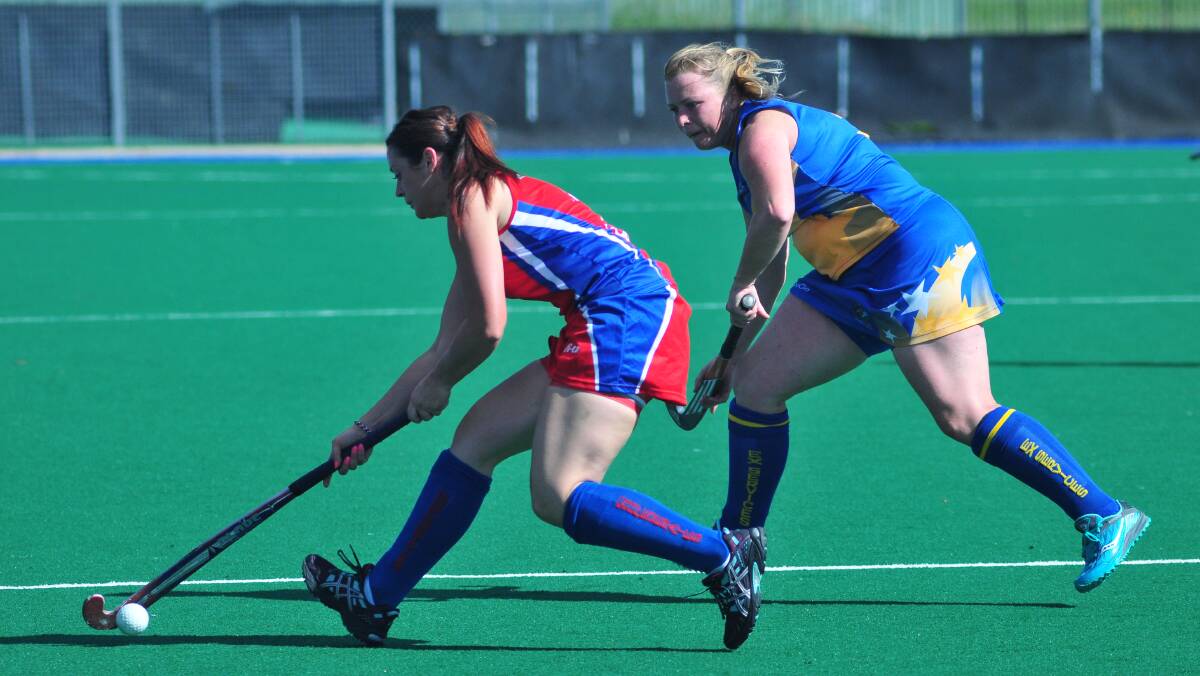 BATTLE: Orange Confederates' Lucy Rheinburger has the ball, but she also has the attention of Orange Ex-Services' Kylie Watts. Photo: JUDE KEOGH