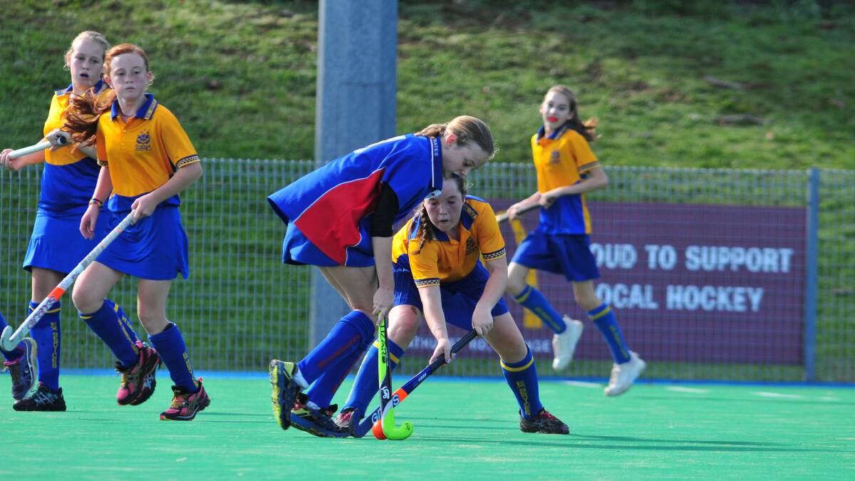 HOCKEY: Lily Morrison and Charlie Wentworth compete hard for the ball on Saturday morning. Photo: JUDE KEOGH