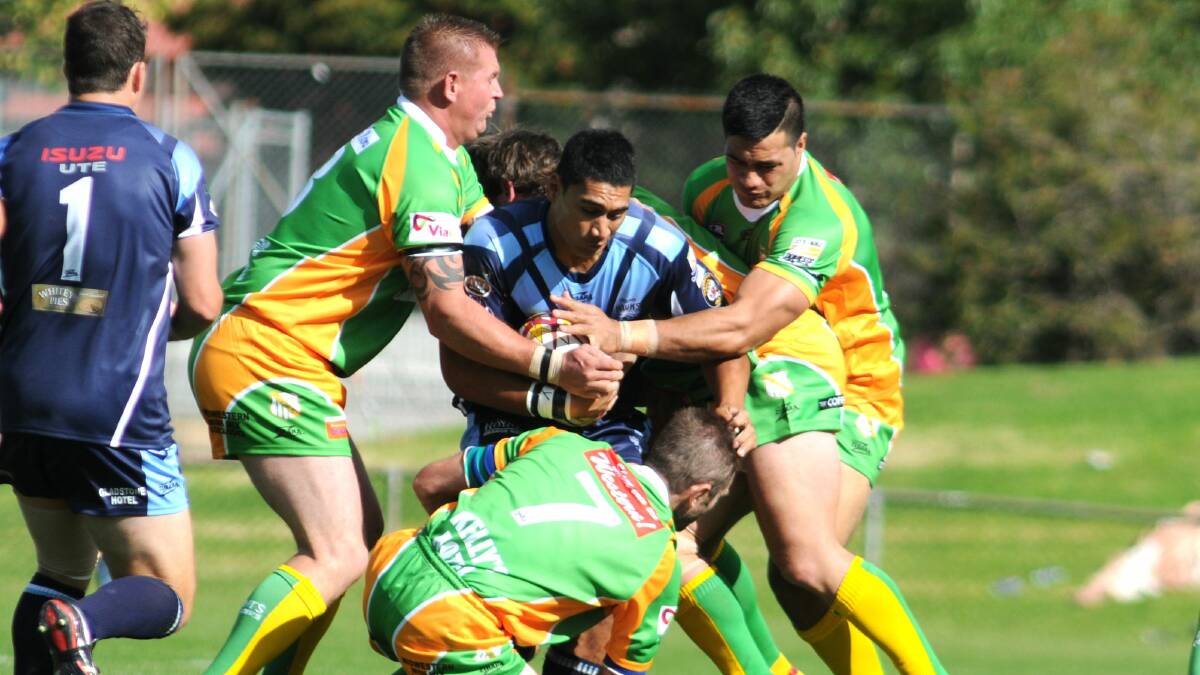 ORANGE HAWKS: Alofi Mataele can't find a way through the green and gold wall on this occasion. Photo: STEVE GOSCH