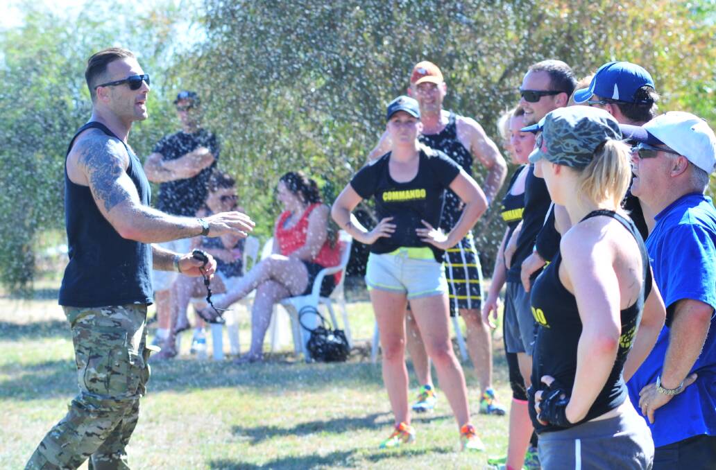 FOLLOW MY LEAD: The Commando lays down the law at his Saturday afternoon boot camp. Photo: JUDE KOEGH