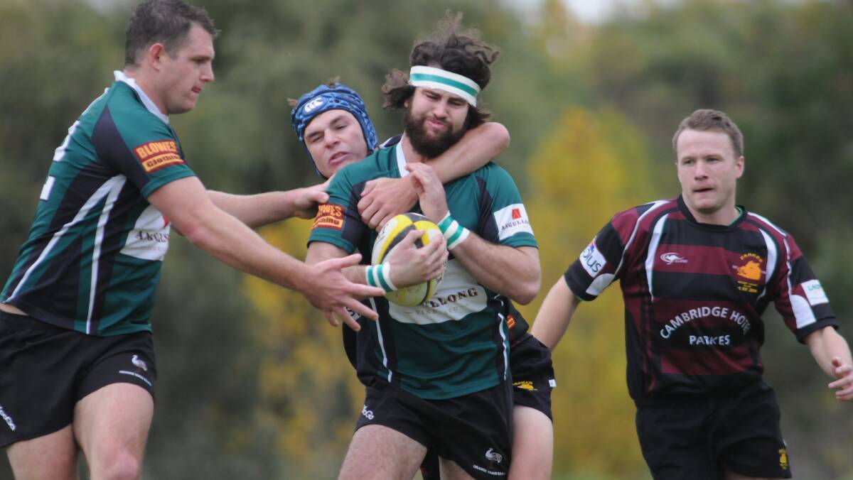 GOT YA: Orange EMus' Tom Green is collared by the Parkes Boars defence in his side's win on Saturday. Photo: STEVE GOSCH