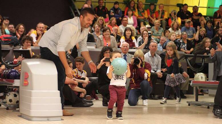 MOVE OVER DAD: Hugo Belmonte about to show his dad Jason how it's done at Sydney's Tenpin City this week.