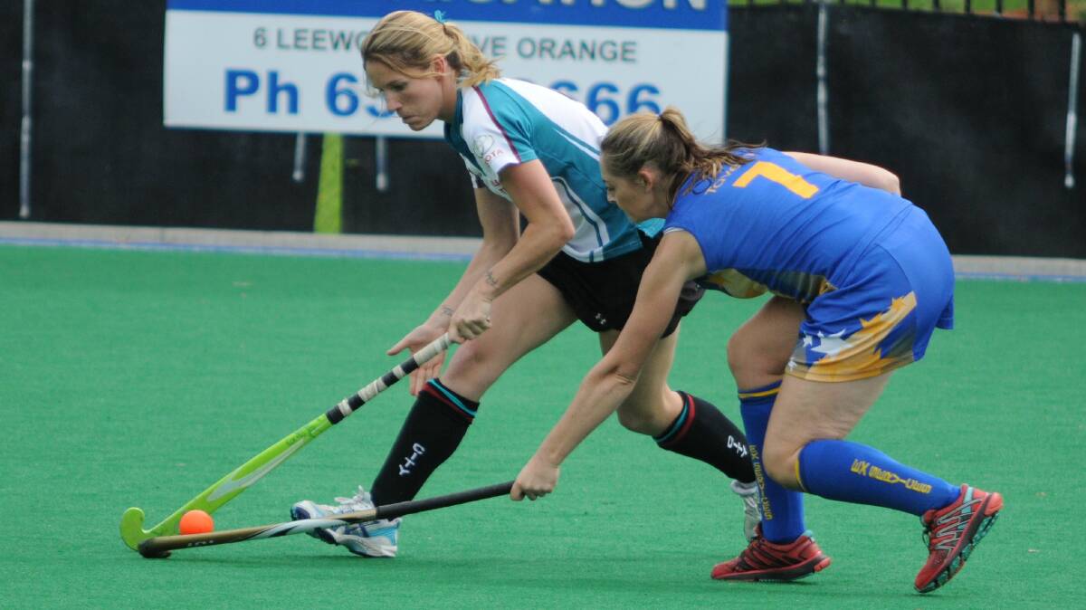 HOCKEY: Bathurst City's Caysey Bayliss and Orange Ex-Services' Leanne Kennewell battle for the ball in Saturday's Premier League Hockey game. Photo: STEVE GOSCH