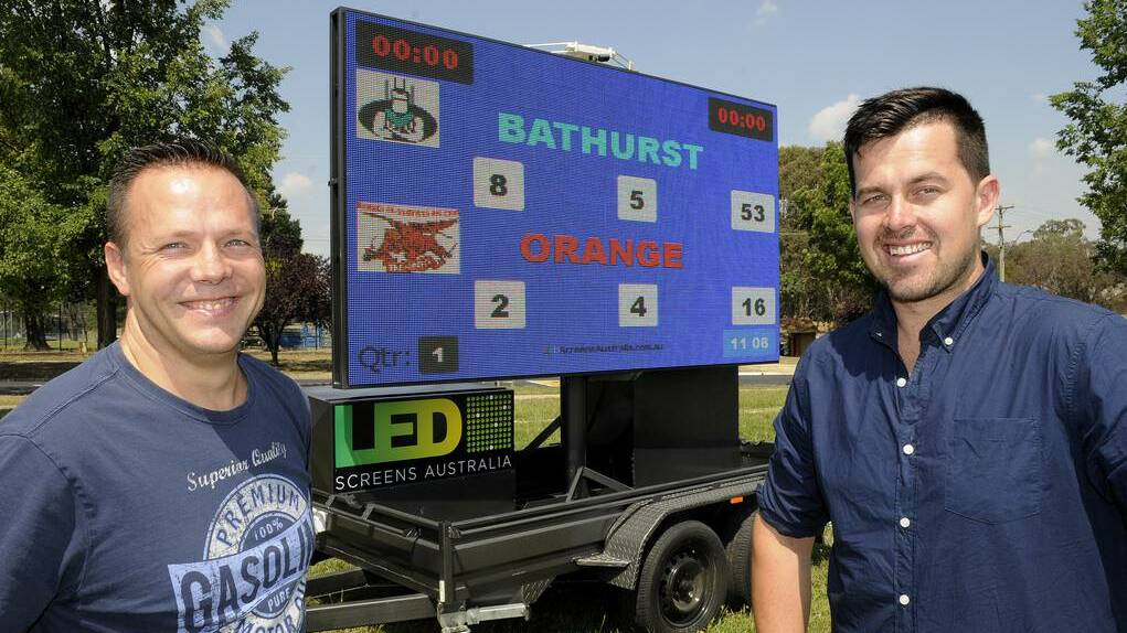 UP IN LIGHTS: Myles Duggan and Daniel Dibley with their mobile LED screen. Photo: CHRIS SEABROOK 010714cscreen