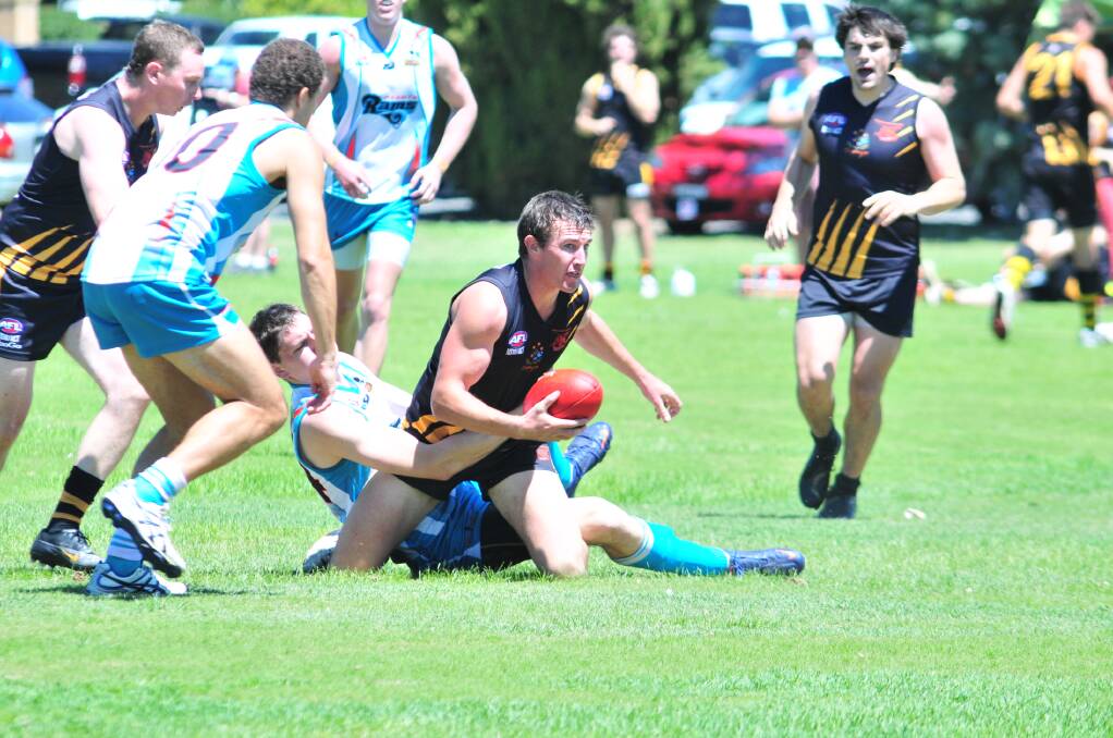 AUSSIE RULES: Josh Bubnich looks for options in the Orange Tigers trial game on Saturday. Photo: JUDE KEOGH