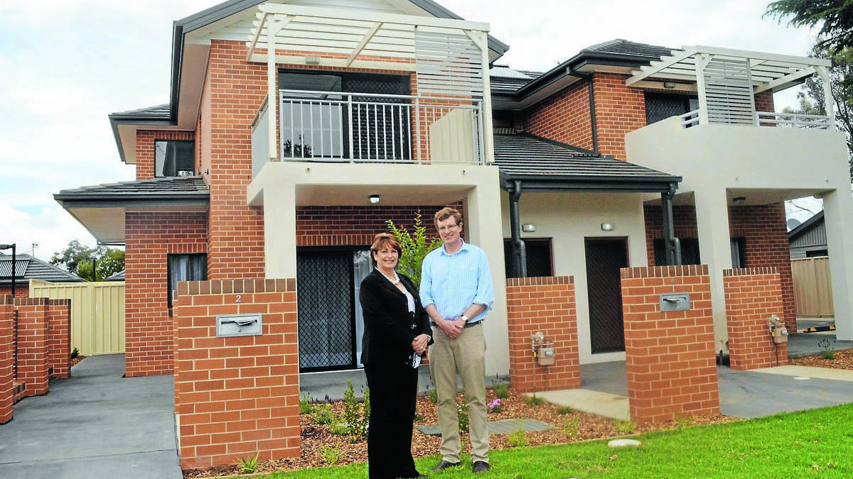 WAITING GAME: Member for Orange Andrew Gee and Housing Plus chief executive officer Karen Andrew outside the Matthews Avenue social housing project. Photo: TRACEY PRISK 1109tphousing8