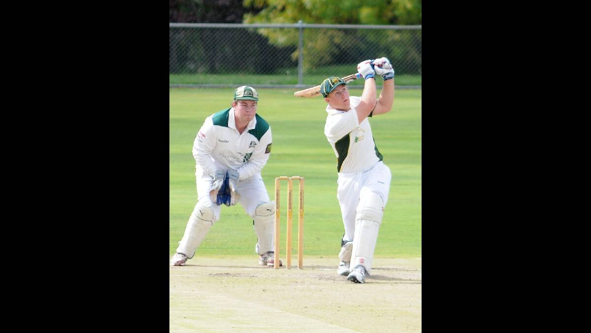 CRICKET: Orange CYMS' Sam Dwyer hits out at as Orange City keeper Matt Findlay looks on at Riawena Oval on Saturday. Photo: STEVE GOSCH