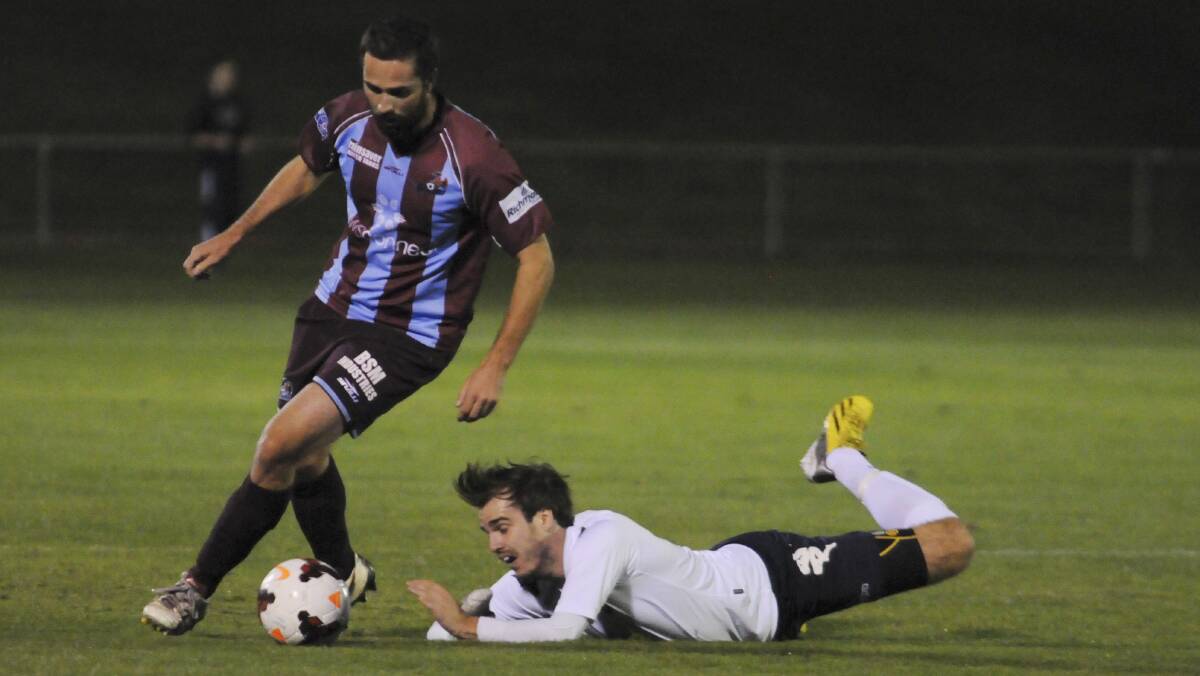 OPENS: Hawkesbury FC's David Gardiner escapes the attention of Western Mariners' James Christie. Photo: JUDE KEOGH