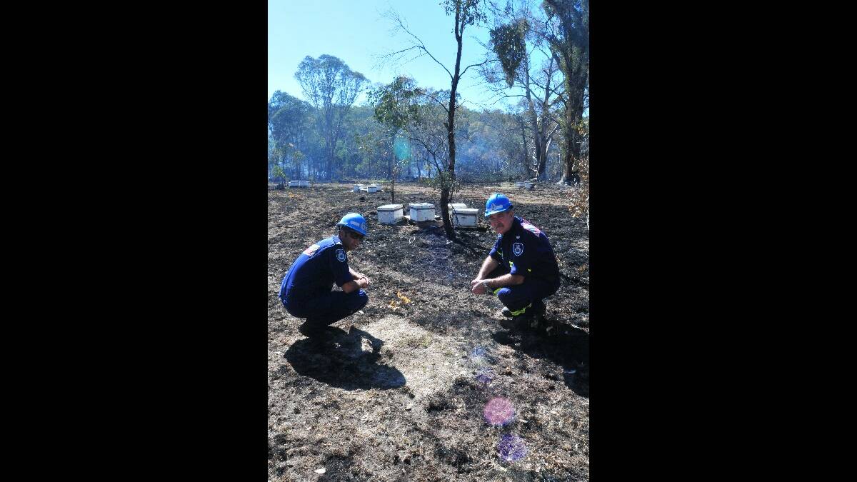 INVESTIGATION: The Rural Fire Service’s Mike Spira and Steve Smith at the site of the Lower Lewis Ponds Road fire yesterday.  Photo: JUDE KEOGH