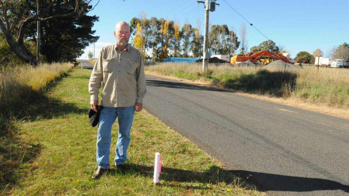 PIPING MAD: David Phillips says residents have not been adequately informed about water and sewer main installation at Shiralee.
					         Photo: JUDE KEOGH 0505pipes2