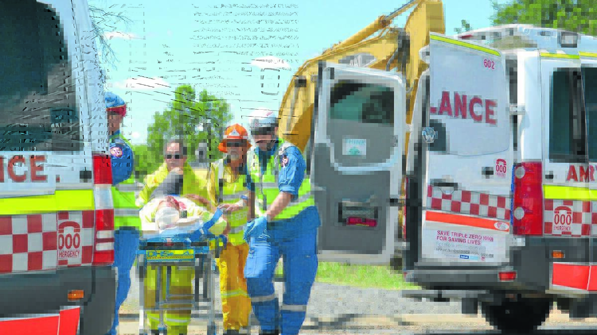 RESCUED: The first of two men to be rescued from a trench cave-in at Eglinton on Thursday receives emergency care. 
Photo: JACINTA CARROLL