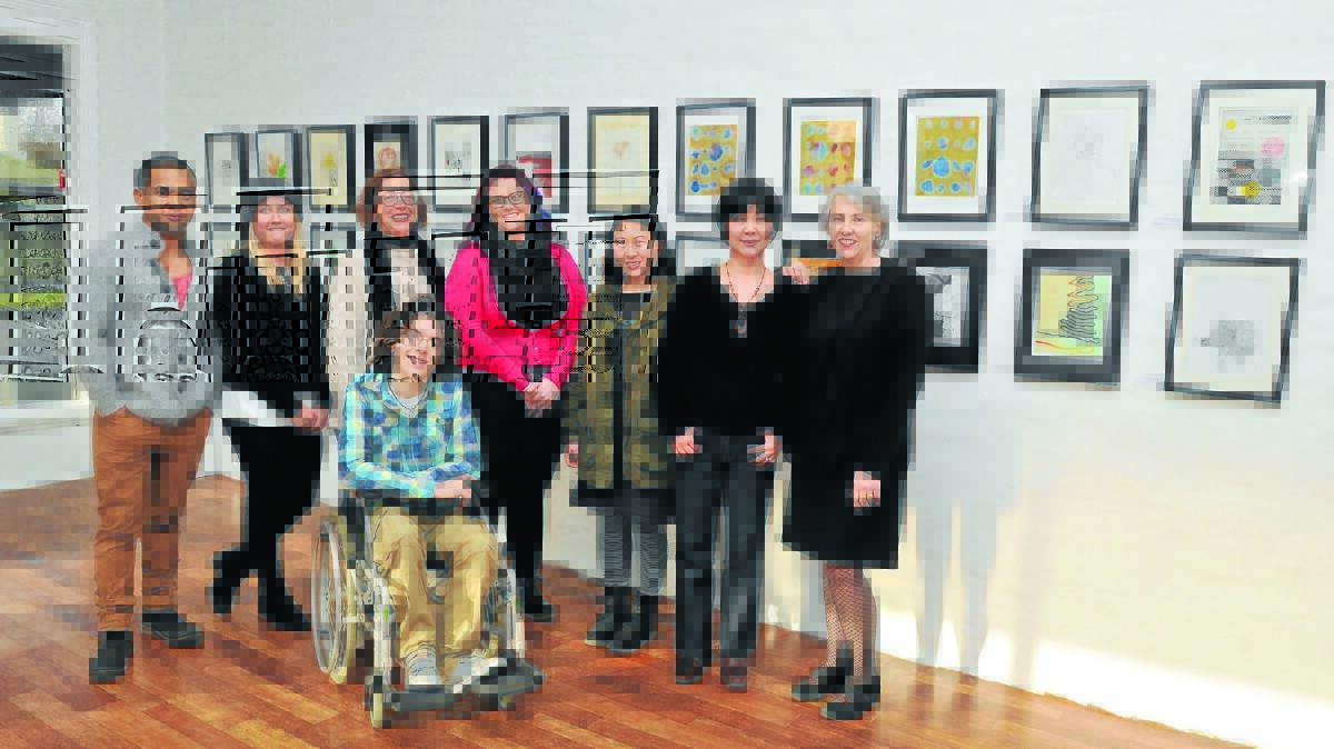 ART COLLECTIVE: The Corner Store Art Gallery owners Erick Holbrow and Madeline Young with artists Jolanta Nejman, Siobhan Fitzpatrick, Jacqueline Chan, Ikuko Fujisawa, Kathryn Jarzabek and Kaluumn Maple (front).
Photo: JUDE KEOGH 0730worksonpaper1