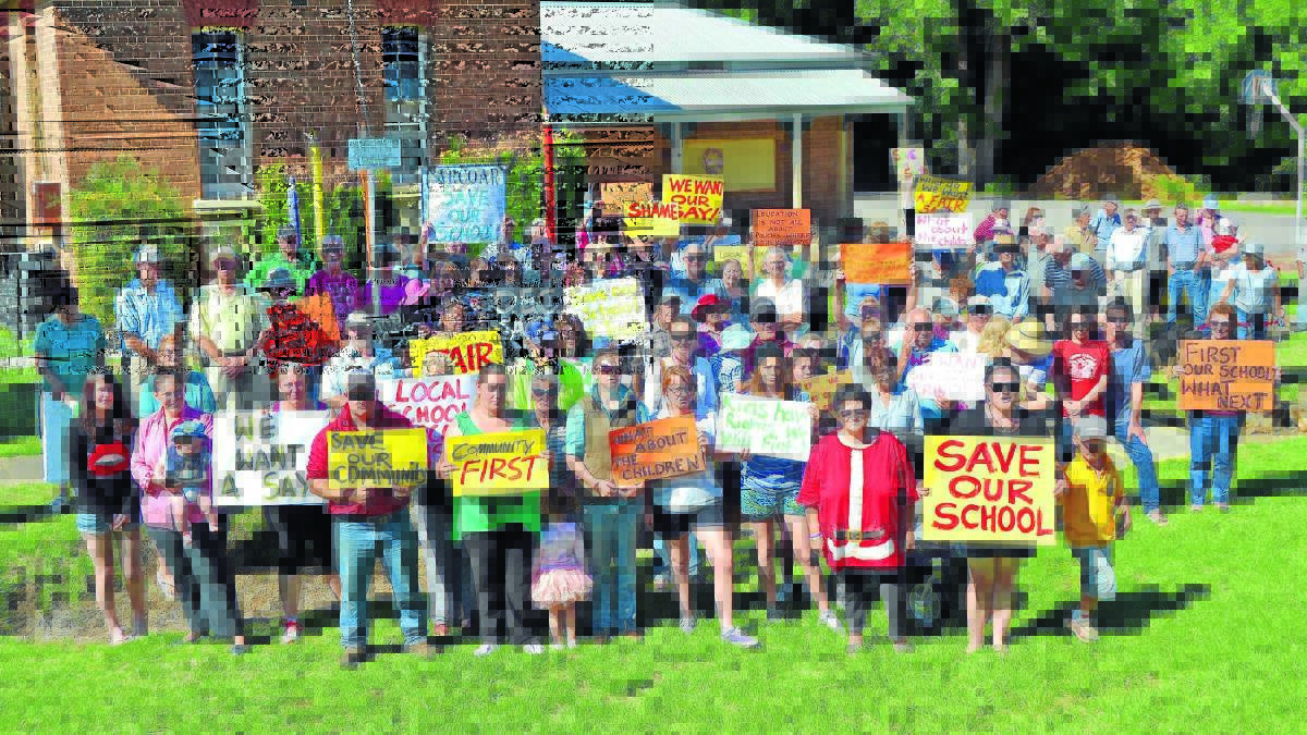 SAVE OUR SCHOOL: About 100 people turned out at a rally at Carcoar Public School to support the outgoing relieving principal. 
Photo: BRYANT HEVESI