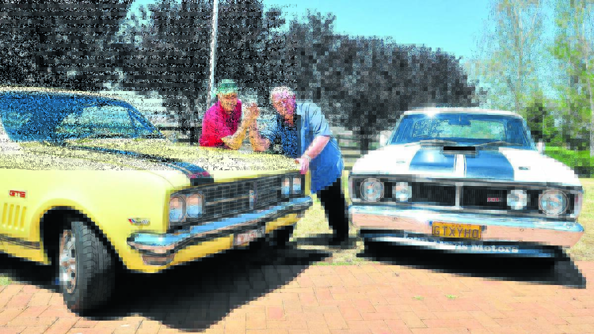 FRIENDLY RIVALRY: Orange councillor Neil Jones with his Holden Monaro and mayor John Davis and his GT HO Falcon prove the rivalry between the two makes of cars still rages. Photo: JUDE KEOGH                                                                                                                              0207gbooblas1
