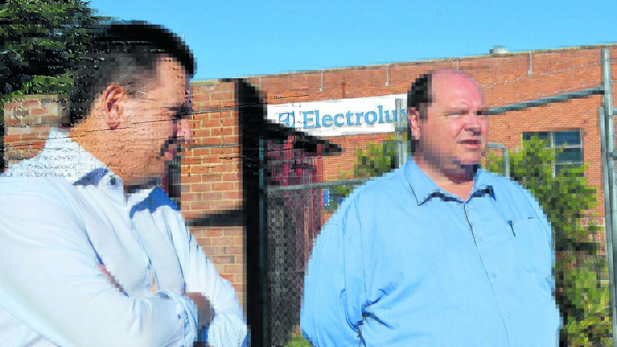 MAJOR ISSUE: Senator Nick Xenophon and Nick Xenophon Team candidate for Calare Rod Bloomfield discuss job losses outside the Electrolux plant yesterday.
Photo: JANICE HARRIS 
