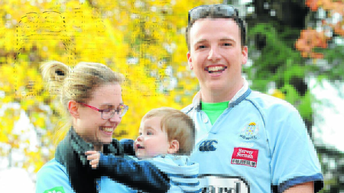 GOOD LUCK CHARM: Jessica Hughes, Nick McGrath and their son Harry McGrath will be cheering for NSW in tonight’s first State of Origin match. 
Photo: JUDE KEOGH 0526origin2