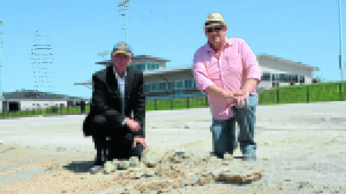 SORTING IT OUT: Bathurst Harness Racing Club chief executive officer Danny Dwyer and president Mark Collins near the sprint lane, the area most affected by a soft surface at the Bathurst Paceway. Photo: PHILL MURRAY                                                                                 102214ptrack2