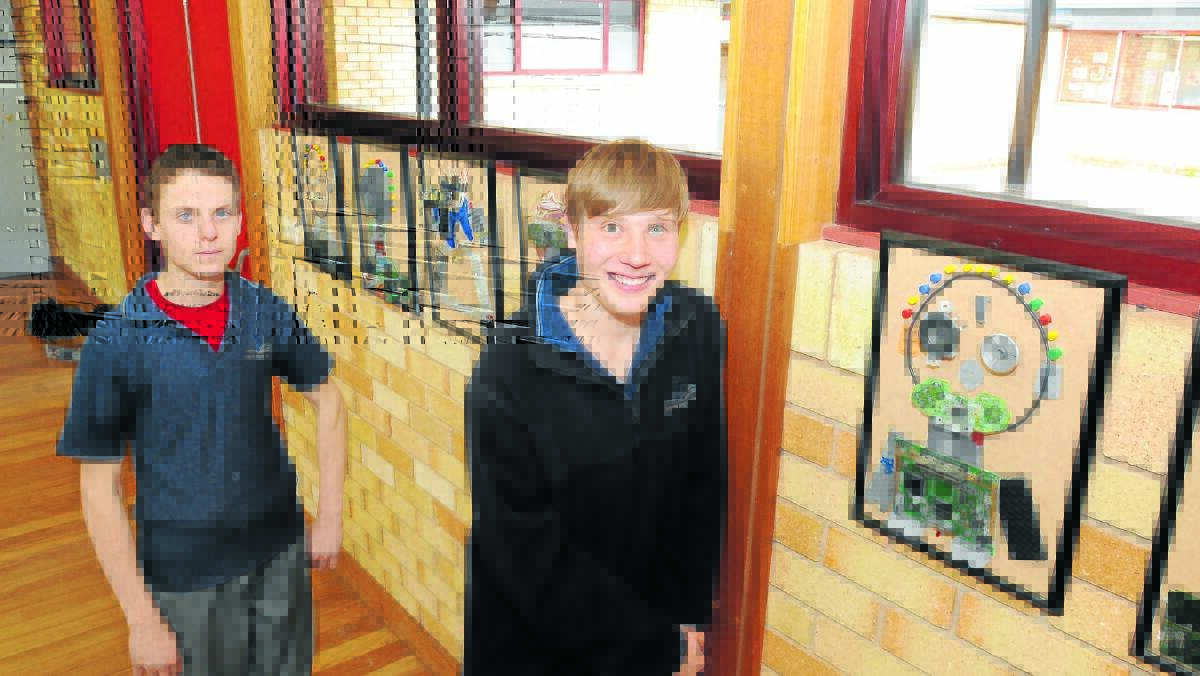 ARTISTIC FLAIR: Anson Street School students John and Jay with their artworks that will be on display in the school as part of Education Week. 
Photo: STEVE GOSCH 0727sgart1