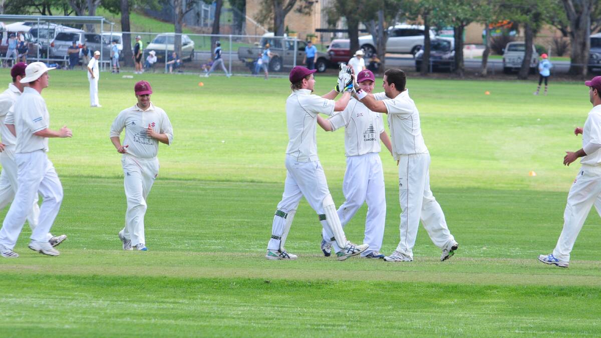 WELL BOWLED: Cavaliers players celebrate one of Chris Martin’s (without hat) four wickets on Saturday.
Photo: JUDE KEOGH 0308cavs1