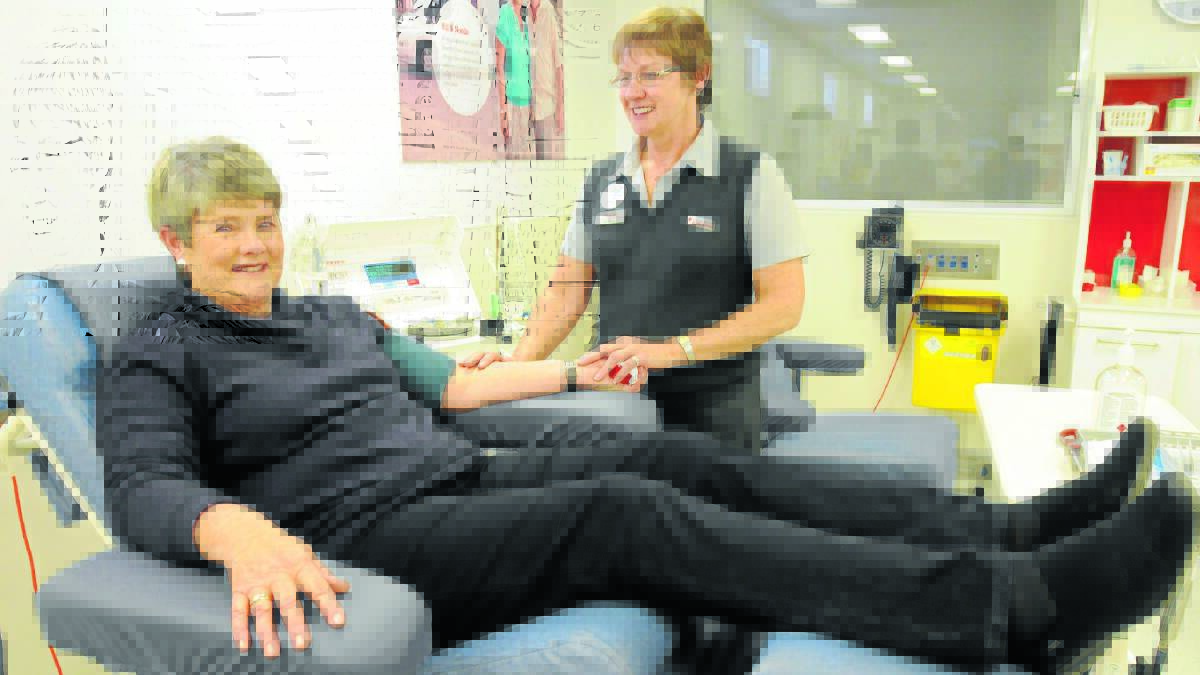  SAVING LIVES: Orange blood bank nurse unit manager Gale Turnbull watches over Rowan Jaffray during one of her 200-plus donations. Photo: STEVE GOSCH                                0729sgblood3
