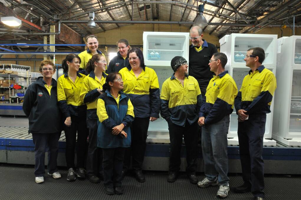 JOB WELL DONE: Electrolux employees who worked on the 420-litre top mount fridge model (back) Taylor Jones, Toni Lovett and David Harvey, (middle) Wendy Waters, Ashlee Pocklington, Kasie Ballard, Kylie McKenzie, Guy Jones, Ian Duboc, production manager Mathew Vickery and (front) Lisa Beath.  Photo: JUDE KEOGH 0723electrolux2
