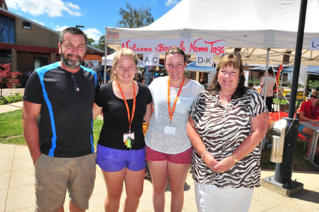 FAMILIAR FACE: Robert Hoogers with his daughter Clare and Chelsea Noon with her mother Lisa  at yesterday's Orientation Week celebration. Even though the girls come from towns hours apart it was a great reunion. Photo: JUDE KEOGH                                                0224oweek7
