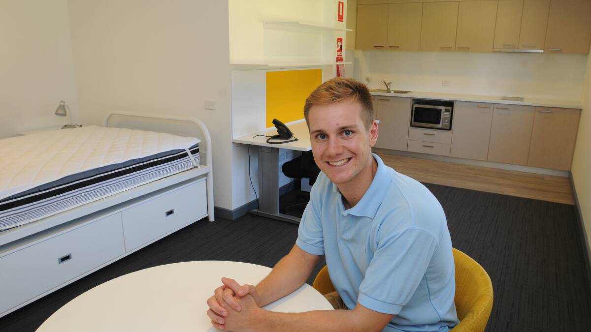 GREEN WITH ENVY: Charles Sturt University dentistry student Tom Ethhell sees the dual bed ensuite rooms for the first time and is extremely jealous of the set-up. 
Photo: STEVE GOSCH  0221sgcsu1
