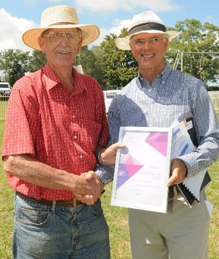 WELL DESERVED: Borenore Community Progress Association president Max Davidson accepts the Borenore Community Group of the Year award from Australia Day ambassador Gordon Bray. 
Photo: JUDE KEOGH 0126cabonne16