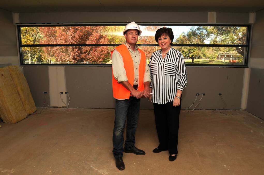 NEARLY THERE: Orange builder Mick Fabar and Ronald McDonald House fundraising committee chair Joanne Lewis, who were at the public meeting nine years ago, view the progress at the site yesterday. If weather permits, the Ronald McDonald House in Orange will be finished and ready for its first occupants in late August.
Photo: STEVE GOSCH 0428sgmh1
