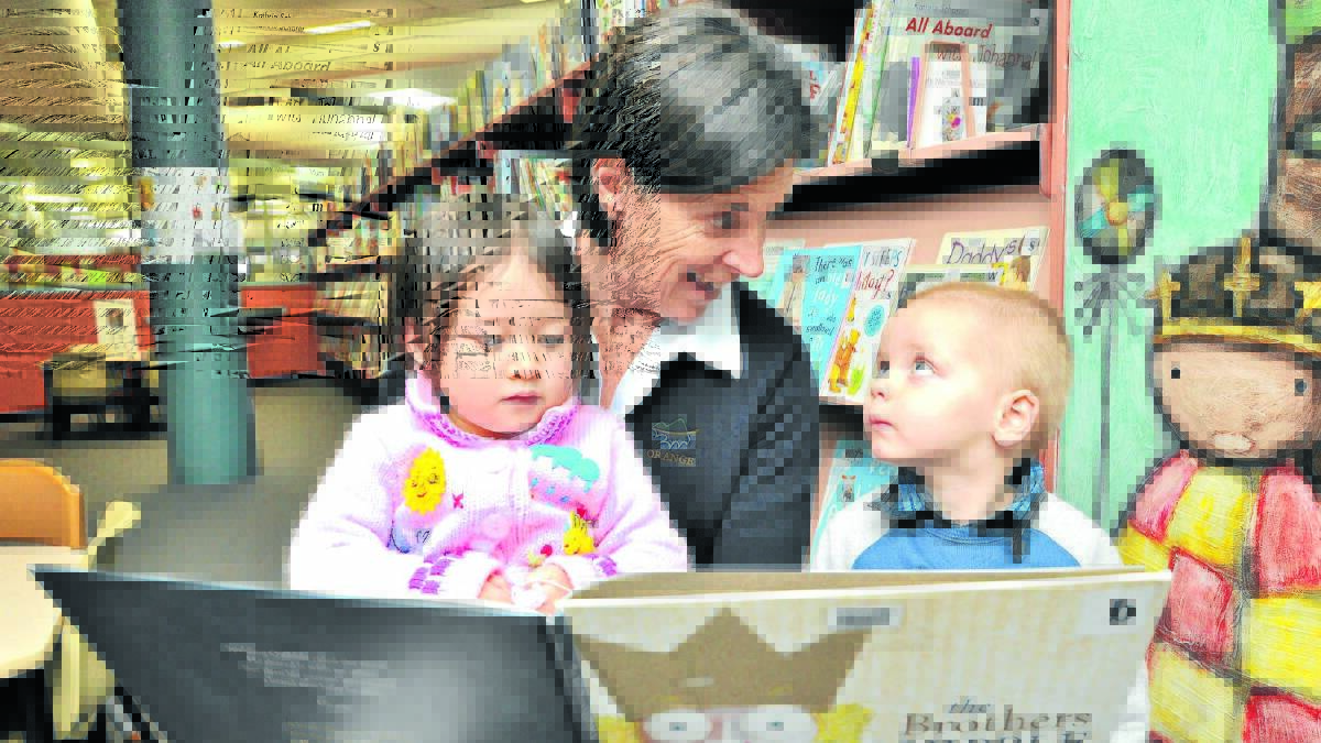 CONNECT THROUGH READING: Two-year-olds Charlotte Gurr and Liam George with National Simultaneous Storytime reader Fiona Hawke. Photo: STEVE GOSCH                                                                                                                                                                            0525sgstory2
